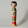 A wooden doll with a colorful design on it.