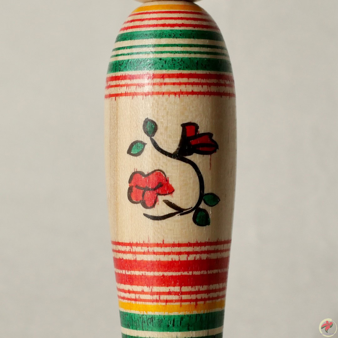A wooden doll with a colorful design on it.